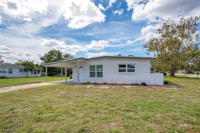 ranch-style home with a front yard and a carport