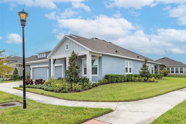 view of side of property with a yard and a garage