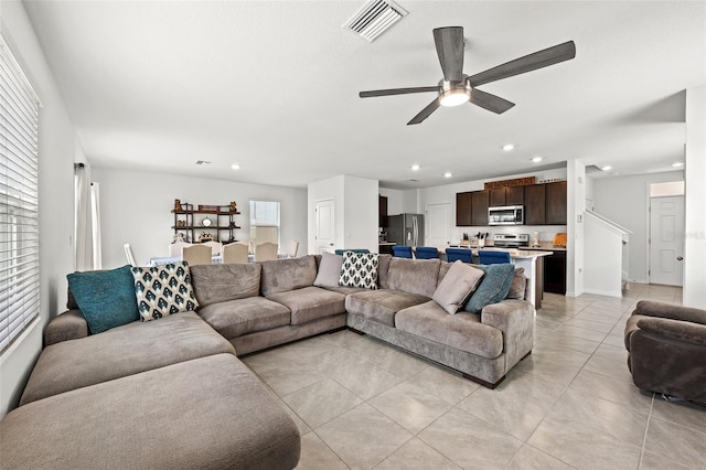 tiled living room featuring ceiling fan