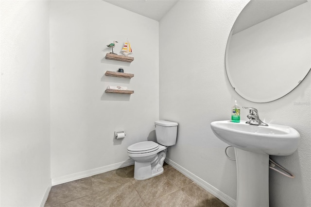 bathroom with tile patterned floors and toilet