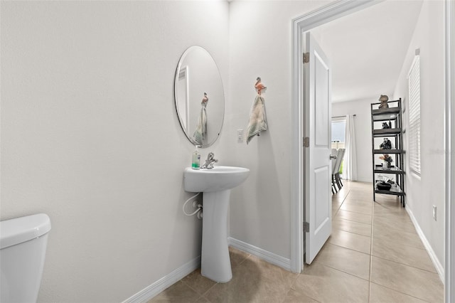 bathroom with tile patterned flooring and toilet