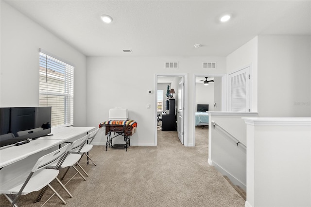 office featuring light carpet and ceiling fan