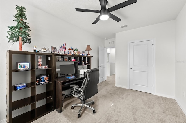 carpeted home office featuring ceiling fan