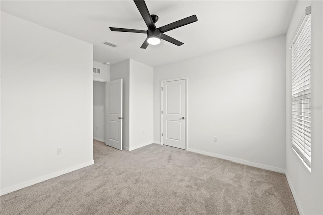 unfurnished bedroom with ceiling fan and light colored carpet