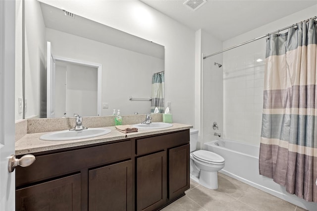 full bathroom featuring tile patterned flooring, vanity, shower / bath combo with shower curtain, and toilet