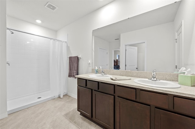 bathroom with curtained shower, tile patterned floors, and vanity