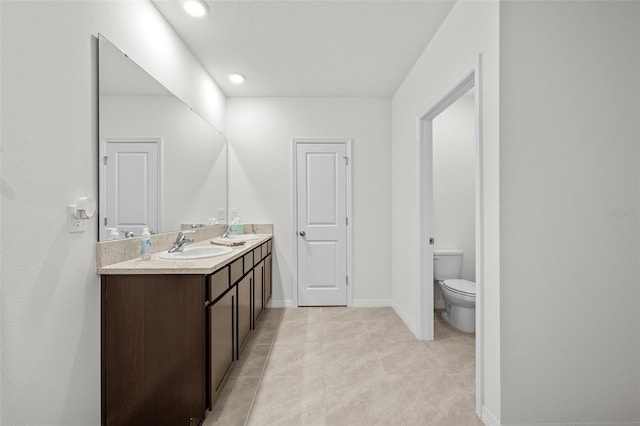 bathroom with tile patterned floors, vanity, and toilet