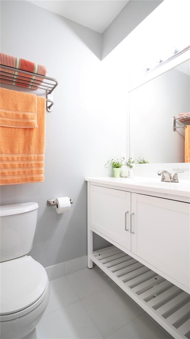 bathroom featuring tile patterned floors, vanity, and toilet