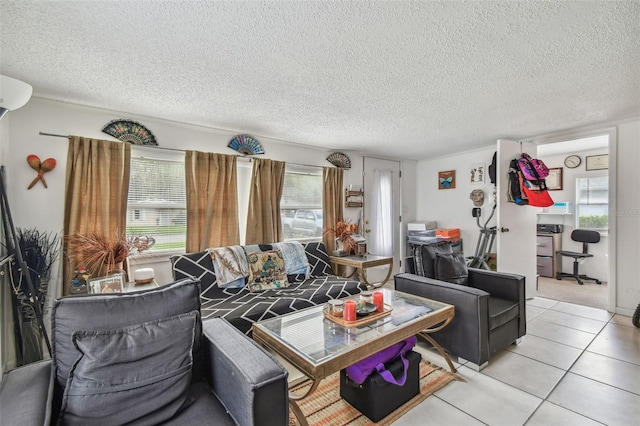 living room with a healthy amount of sunlight, light tile patterned floors, and a textured ceiling