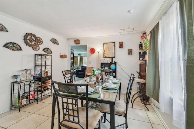 tiled dining room with ornamental molding