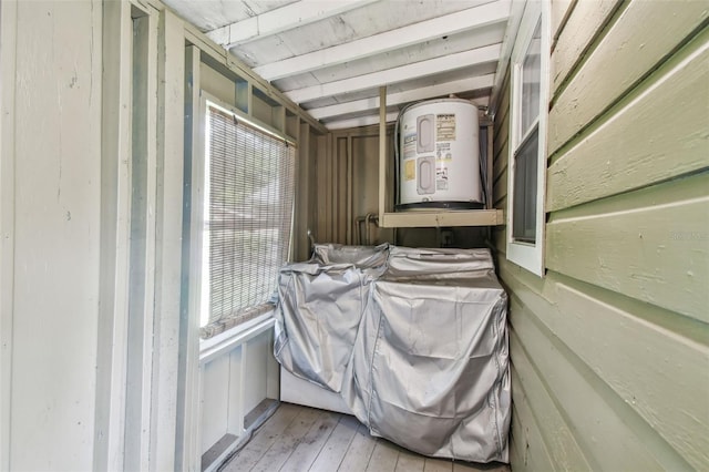 clothes washing area featuring light hardwood / wood-style floors