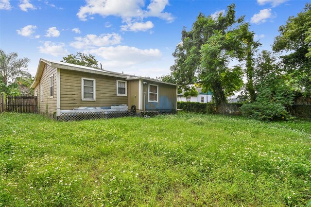 back of house featuring a yard