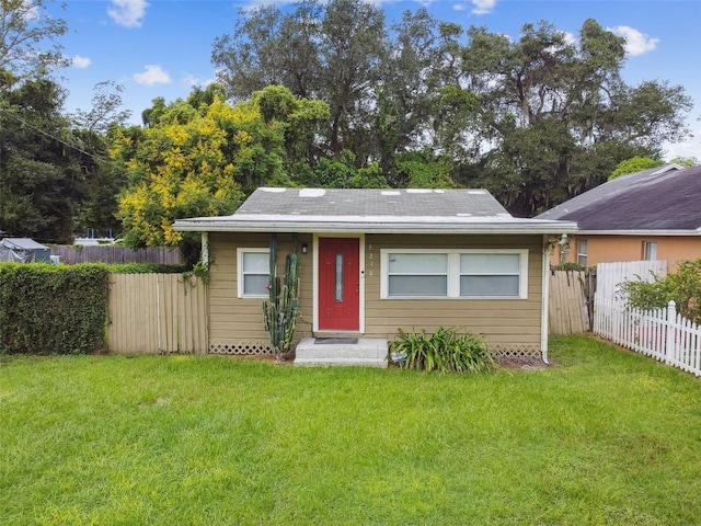 ranch-style home with a front lawn