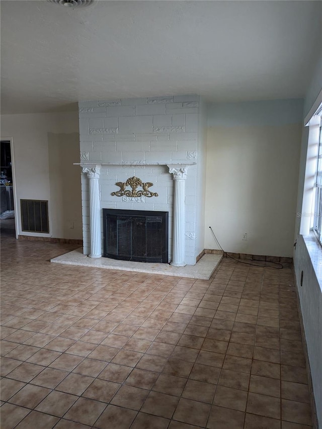 unfurnished living room featuring a fireplace and tile patterned flooring