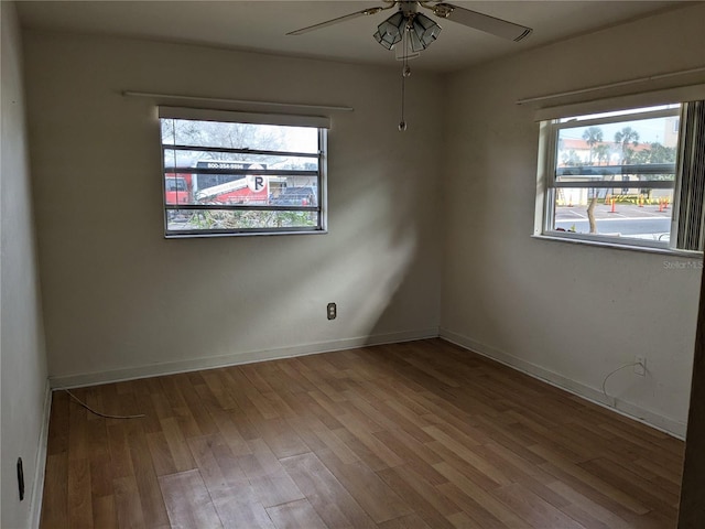 empty room with hardwood / wood-style flooring and ceiling fan