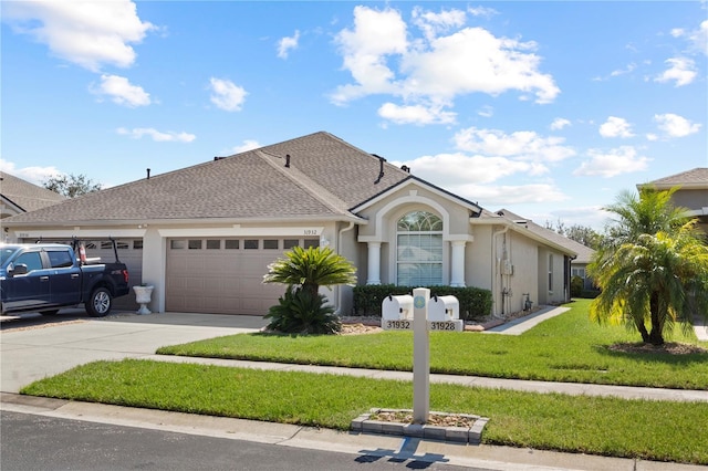 view of front of property featuring a garage and a front yard