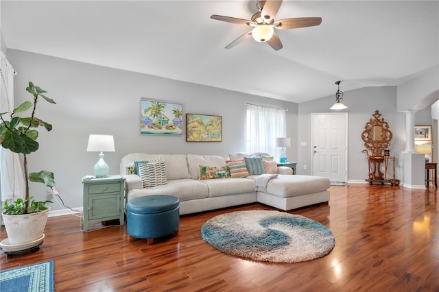 living room with decorative columns, ceiling fan, wood-type flooring, and lofted ceiling