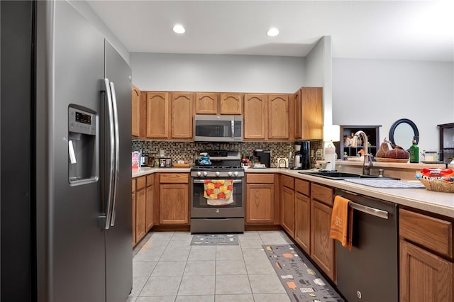 kitchen with decorative backsplash, sink, stainless steel appliances, and light tile patterned flooring