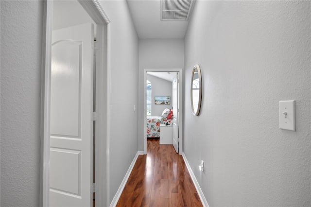 hallway with hardwood / wood-style floors