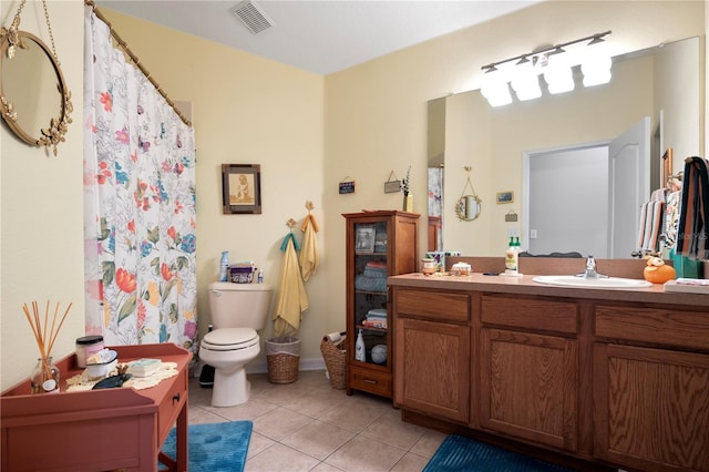 bathroom featuring tile patterned floors, vanity, and toilet