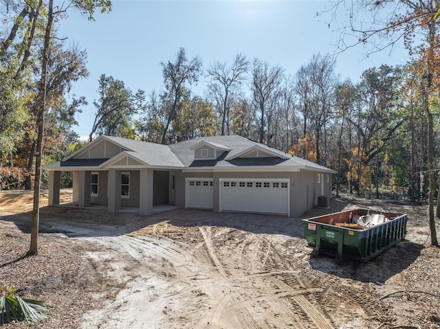 view of front of property featuring cooling unit and a garage