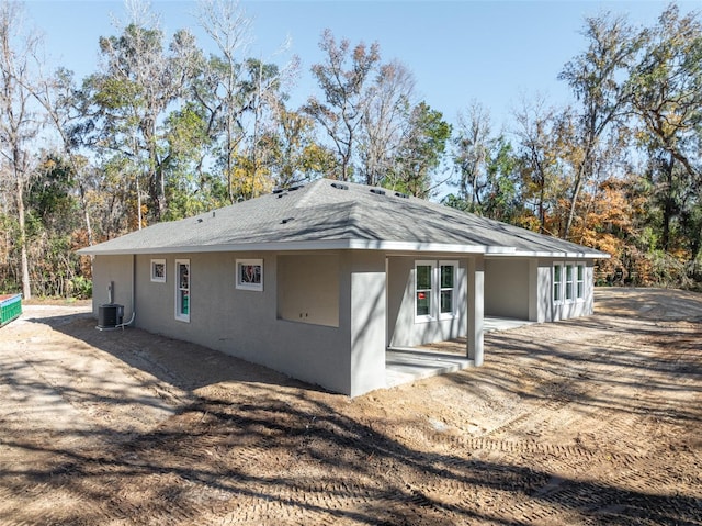 back of property with a patio area and central AC unit