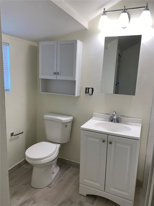 bathroom with hardwood / wood-style flooring, vanity, and toilet