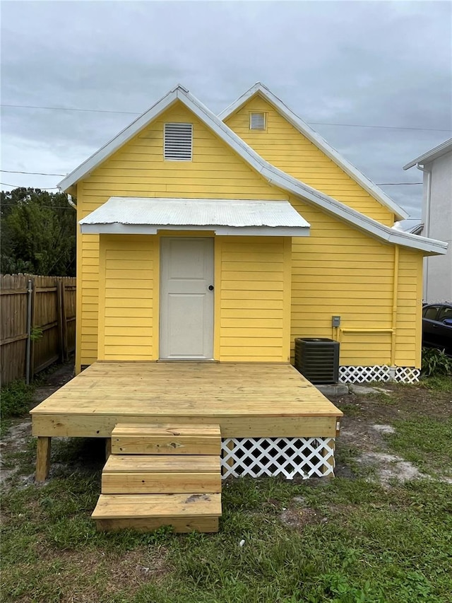 back of property featuring cooling unit and a deck