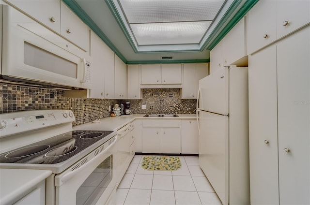 kitchen featuring sink, light tile patterned floors, white appliances, decorative backsplash, and white cabinets