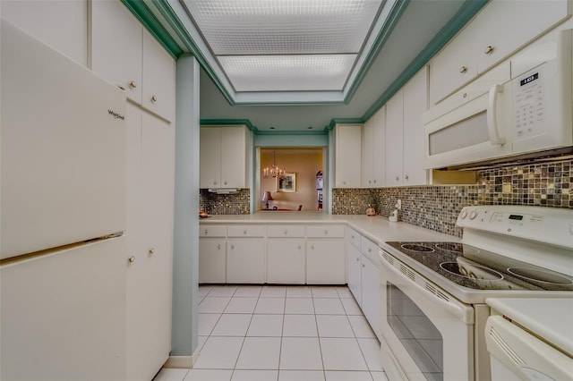 kitchen featuring light tile patterned floors, white cabinets, and white appliances