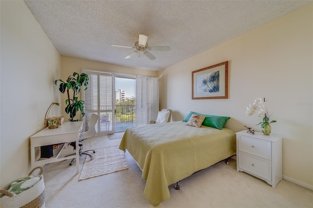 bedroom featuring light carpet, a textured ceiling, access to exterior, and ceiling fan