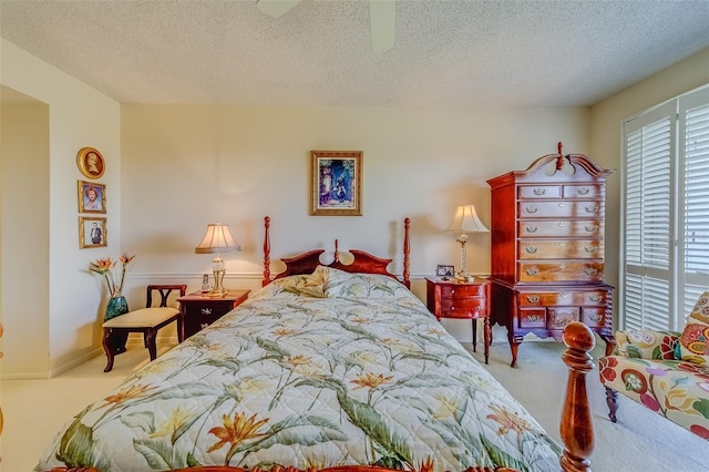 bedroom featuring a textured ceiling, ceiling fan, and carpet flooring