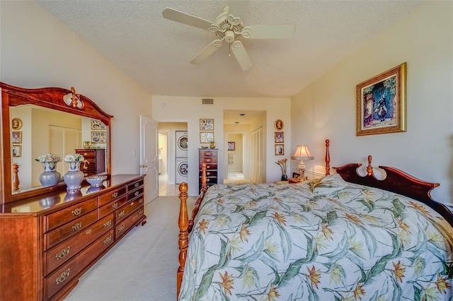 carpeted bedroom with ceiling fan and a textured ceiling