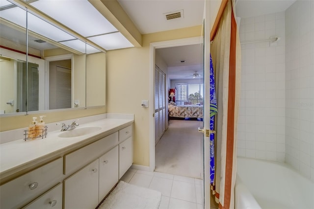 bathroom with ceiling fan, shower / tub combo with curtain, vanity, and tile patterned flooring