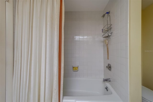 bathroom with shower / bath combo with shower curtain