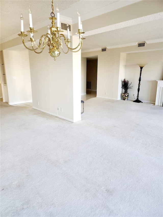 unfurnished room with ornamental molding, carpet, a textured ceiling, and a notable chandelier