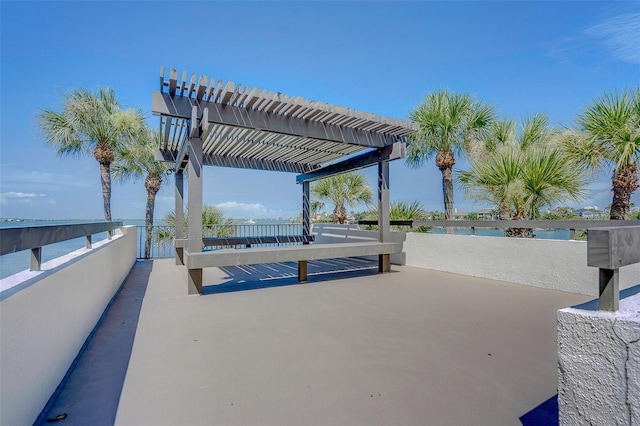 view of patio / terrace featuring a water view and a pergola