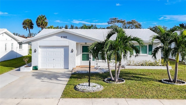 ranch-style house featuring a garage and a front lawn