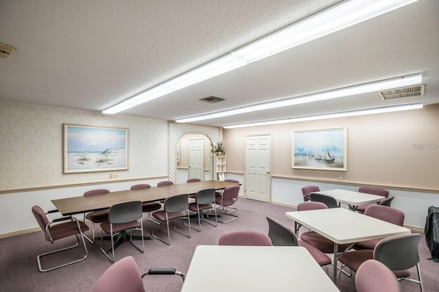 dining area with carpet flooring and a textured ceiling