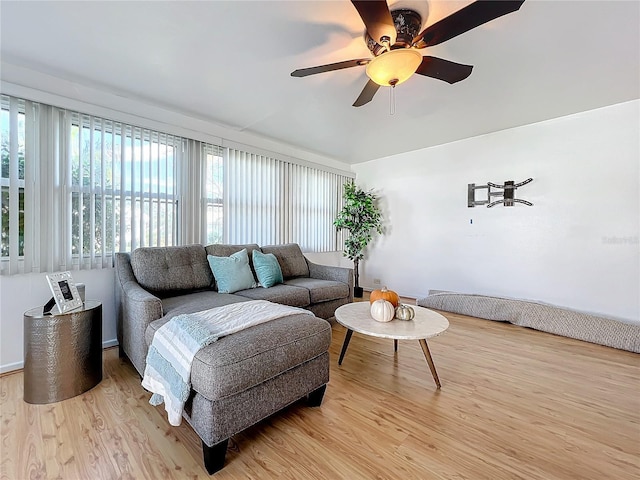 living room with ceiling fan and light hardwood / wood-style flooring