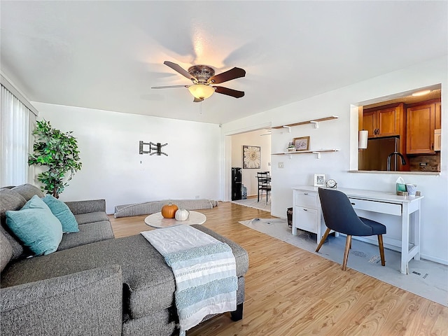 living room featuring ceiling fan and light hardwood / wood-style flooring