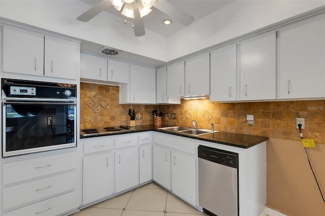 kitchen featuring light tile patterned flooring, white cabinetry, black oven, stainless steel dishwasher, and decorative backsplash