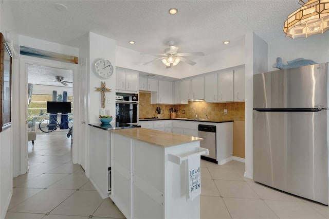 2298 Netherlands Dr Unit 4, Clearwater, FL 33763 - kitchen featuring appliances with stainless steel finishes, ceiling fan, tasteful backsplash, recessed lighting, and a textured ceiling