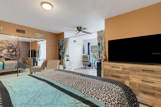 bedroom featuring a textured ceiling and ceiling fan