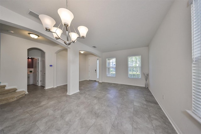 spare room with a chandelier