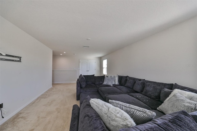 carpeted living room with a textured ceiling