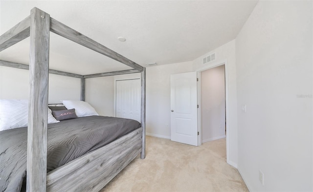 bedroom with a closet and light colored carpet