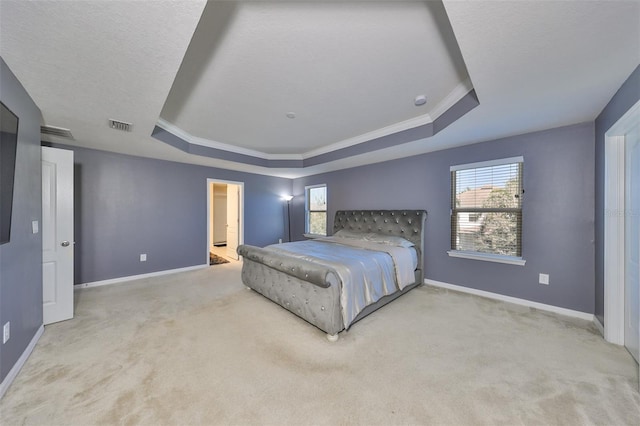 bedroom featuring light carpet, ornamental molding, and a tray ceiling