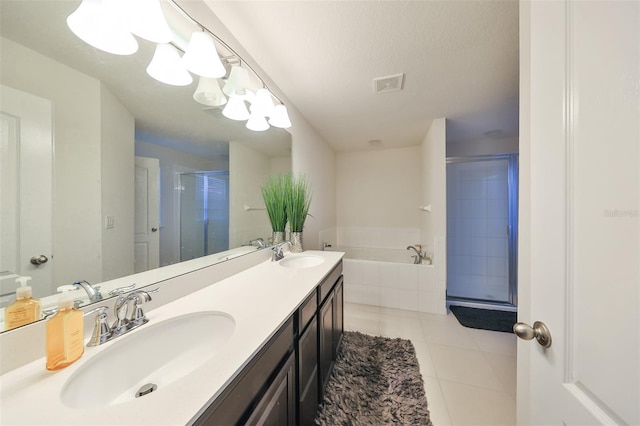 bathroom featuring vanity, a textured ceiling, plus walk in shower, and tile patterned flooring