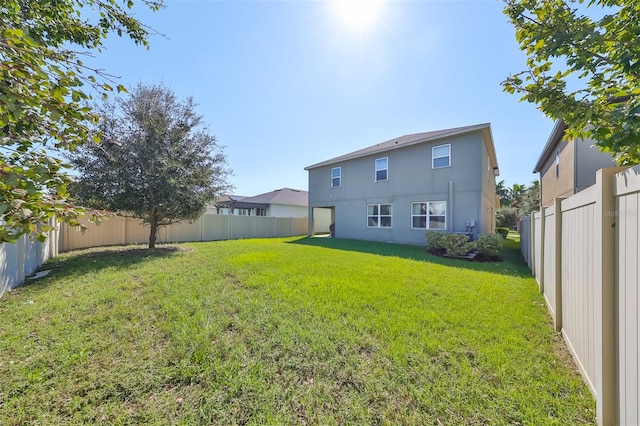 rear view of property with a lawn